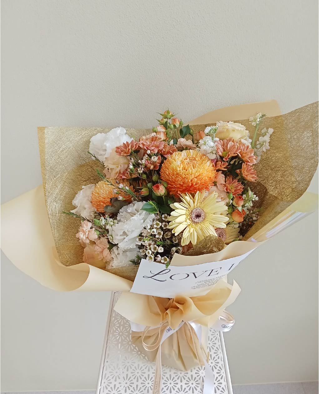 A vibrant 'Autumn Bliss' bouquet with orange chrysanthemums, peach roses, and yellow gerberas, the perfect gift in Phuket.