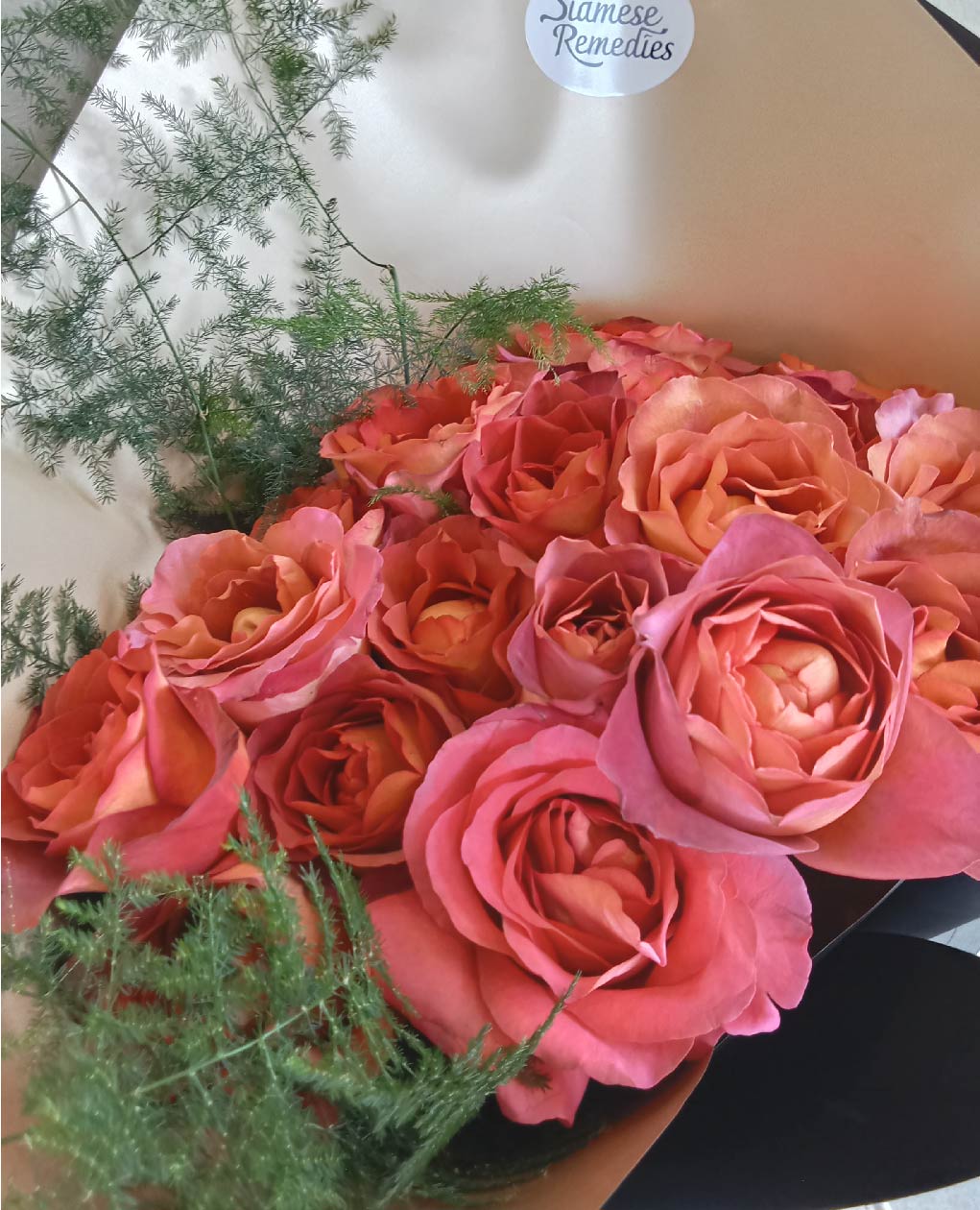 Blushing Romance bouquet with pink and peach roses, accented by ferns, perfect for celebrating love in Phuket.