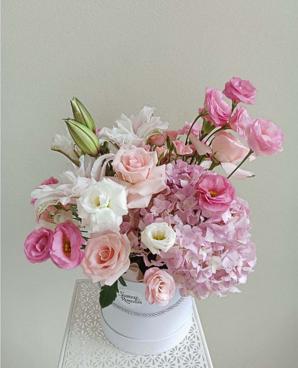 Elegant bouquet of pink roses, lisianthuses, lilies, and hydrangeas in a white box. Ideal for romantic occasions and Phuket flower delivery.