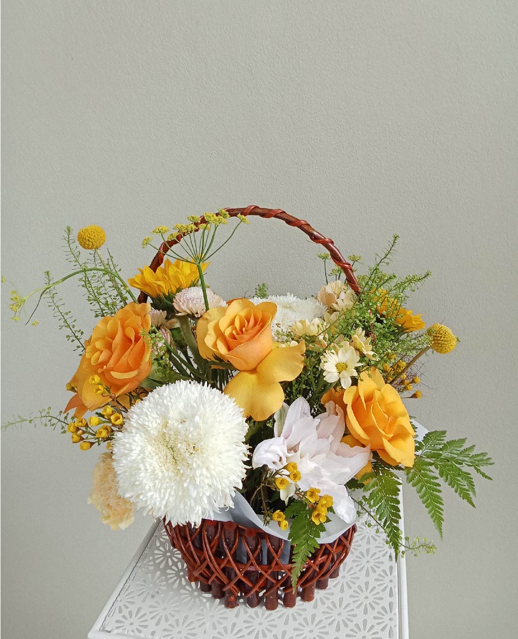 Golden Glow bouquet with yellow roses, white chrysanthemums, craspedia, and daisies in a basket. Perfect flowers in Phuket for any joyful occasion.