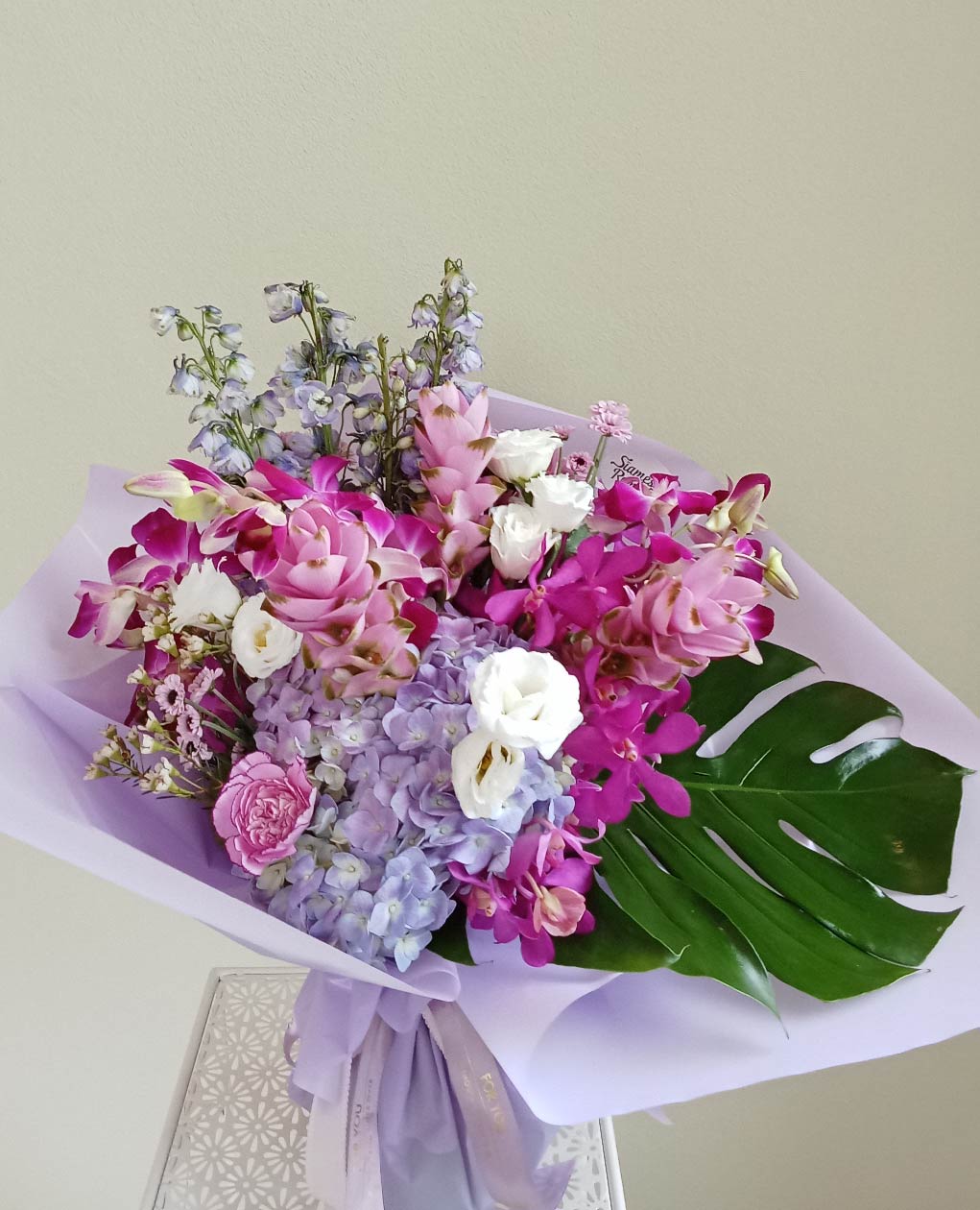 Elegant Purple Serenity bouquet with hydrangeas, orchids, and lisianthuses. Phuket flowers that are perfect for special occasions.