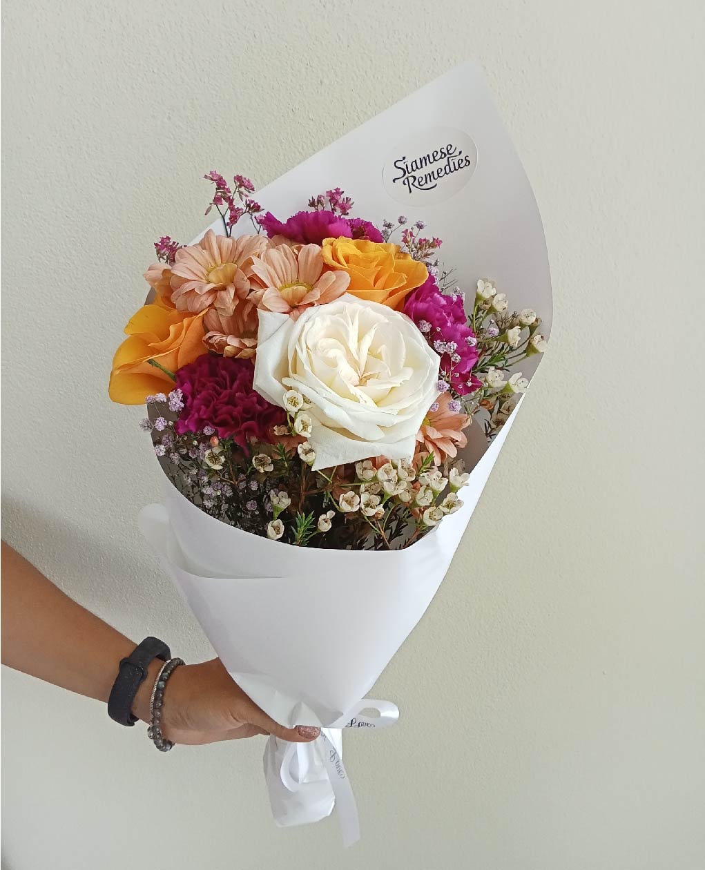 Sweet Harmony bouquet with white roses, orange chrysanthemums, and purple statice, a vibrant flower arrangement perfect for Phuket occasions.